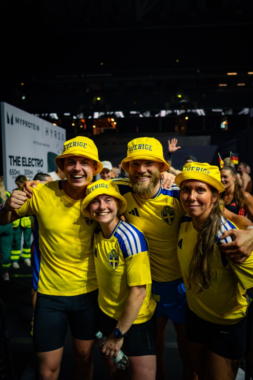 Glada deltagare i gula Sverige-tröjor på ett event.